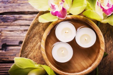 Yeşil ve mor orkide ve ahşap masa, seçici odak mum