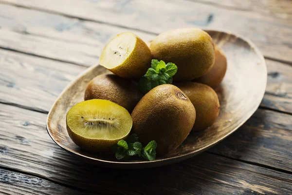 Fresh sweet gold kiwi on the wooden table, selective focus image