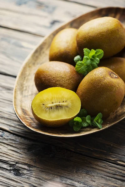 Fresh sweet gold kiwi on the wooden table, selective focus image