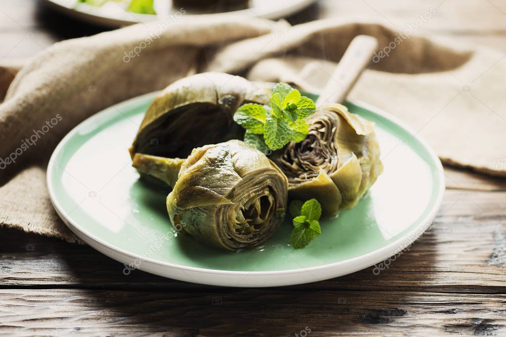 Traditional italian artichoke with mint and garlic, selective focus