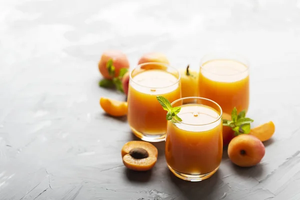 Fresh apricot juice on the marble table — Stock Photo, Image