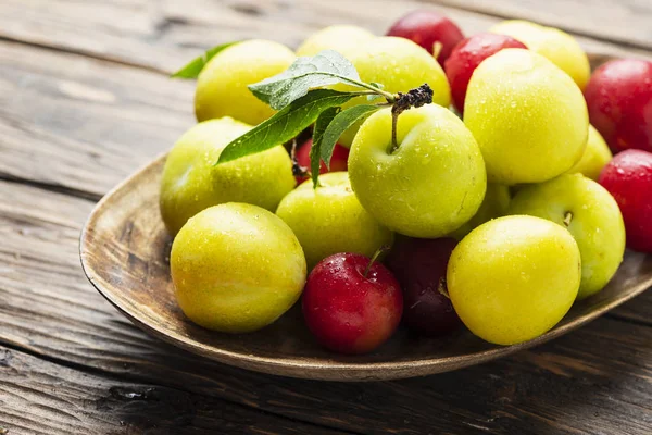 Fresh sweet plums on the wooden table — Stock Photo, Image