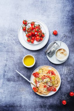 Geleneksel İtalyan makarnası, domates, kabak ve parmesan peyniri. Sağlıklı vejetaryen yemeği kavramı. Kopyalama alanı ile üstten aşağı görünüm