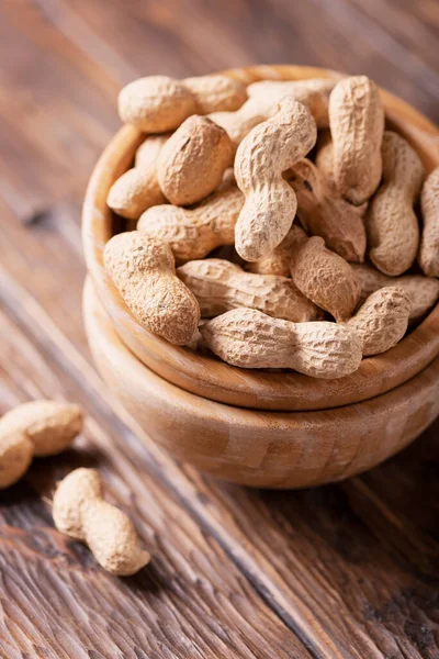 Roasted peanuts on the wooden table