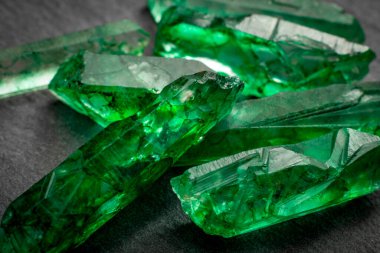 Closeup of a bunch of many green rough uncut emerald crystals clipart