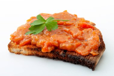 Traditional food from Romania concept with vegetable spread (Romanian: zacusca) on one single slice of toast bread isolated on white background clipart