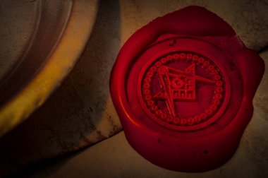 Freemason secret symbol concept with vintage letter under a candle, sealed with red wax seal with the square, the compass and the G letter in the middle, one of the most identifiable masonic symbols clipart