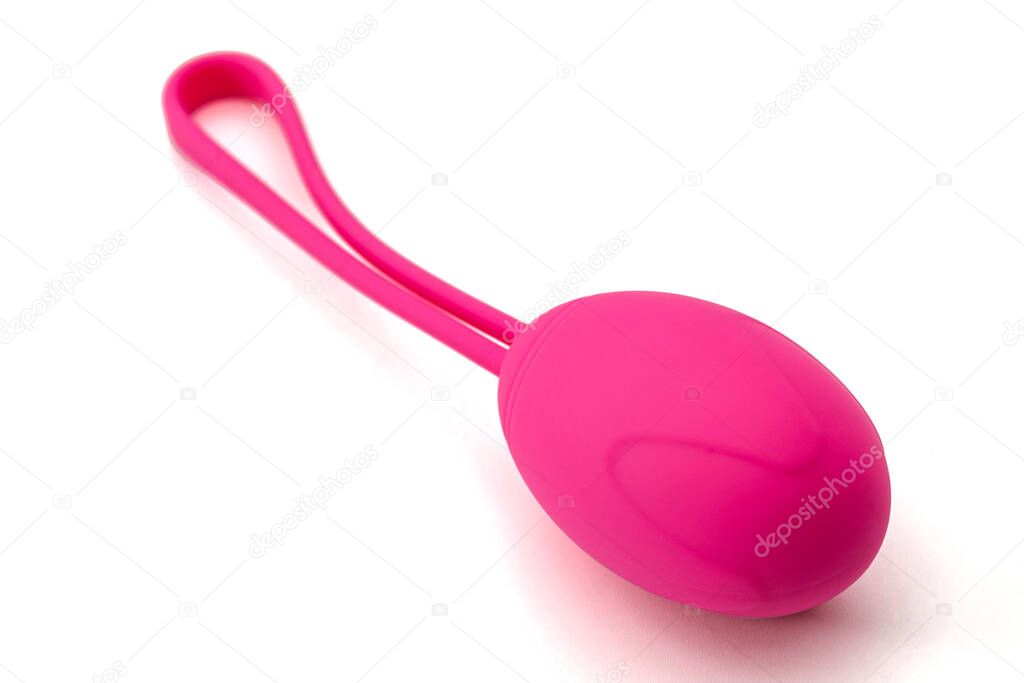 Metaphor for pelvic floor exercise and intimate health for better sexual performance concept with close up on one single pink kegel weight isolated on white background with clipping path cutout
