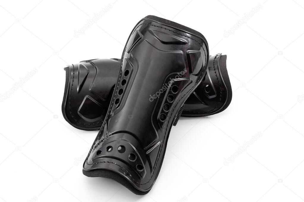 Football equipment, injury and bruise prevention and soccer gear concept with tough black shin guards isolated on white background with clipping path cutout