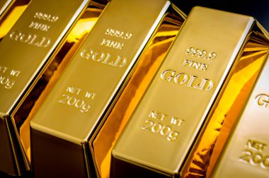 National reserve of gold, financial stability and commodity trading concept with many pure solid gold bars in a raw on black background with copy space clipart