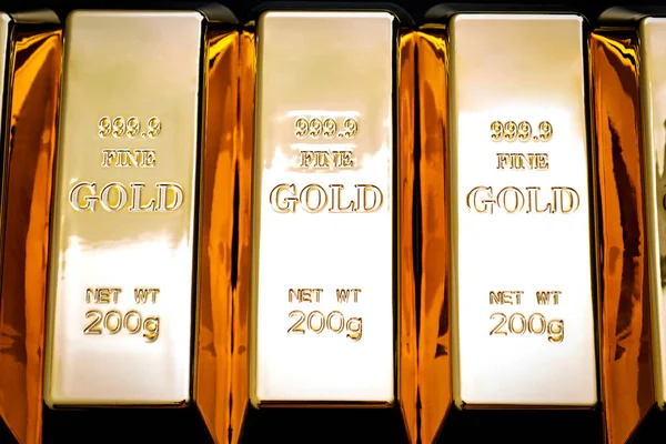 National reserve of gold, financial stability and commodity trading concept with many pure solid gold bars in a raw on black background