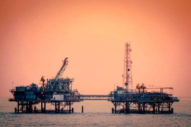 Oil platform silhouette in gulf of mexico clipart