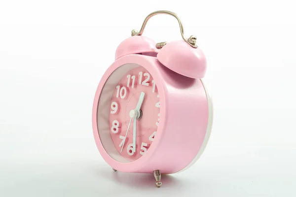 Sleep hygiene, wake up ring and old fashioned clocks concept with pink retro style alarm clock isolated on white background and clipping path cutout