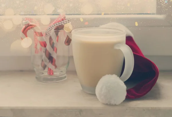 Cup of coffee on window sill — Stock Photo, Image