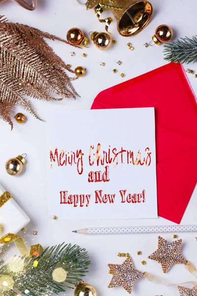 Christmas flat lay scene with letter to santa claus scene with golden decorations, copy space on white paper with Merry Christmas and Happy New Year greetings