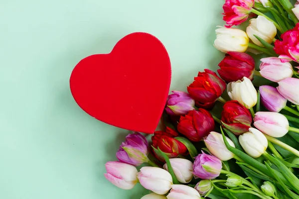 Fresh tulips flowers with heart — Stock Photo, Image