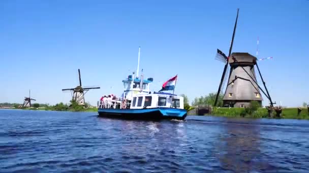Dutch windmill over river waters — Stock Video