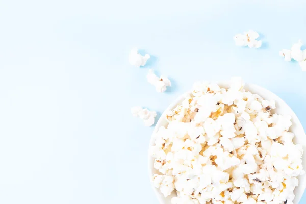 Scattered popcorn over yellow background — Stock Photo, Image
