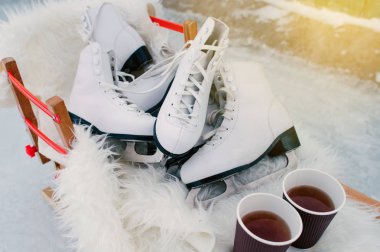 Buz birkaç çift ahşap kızak üzerinde 2 su bardağı coffie ayakta skates.