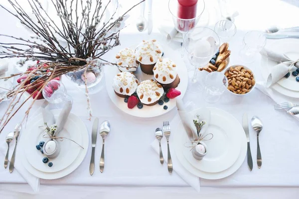 Simple festive Easter table setting with napkin Easter Bunny and pussy willow