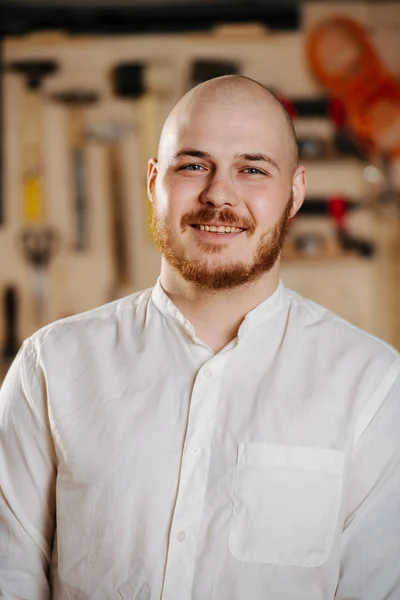 Portrait of a carpenter in his workshop.