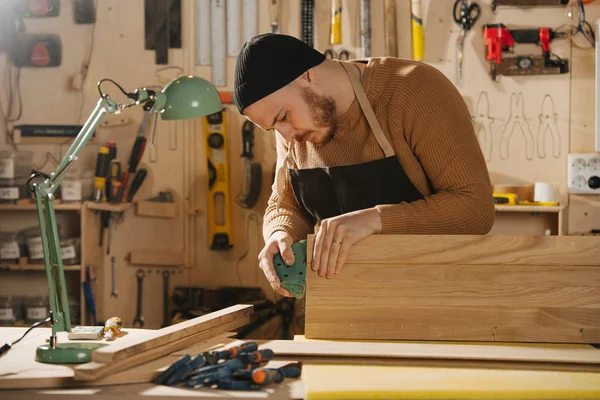 Charpentier fabrique des meubles sur commande dans un atelier . — Photo