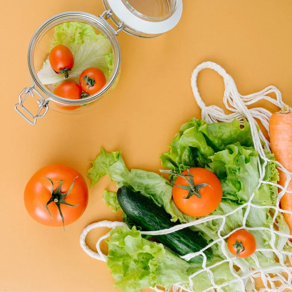 String bag with vegetables on a colored background — Stock Photo, Image