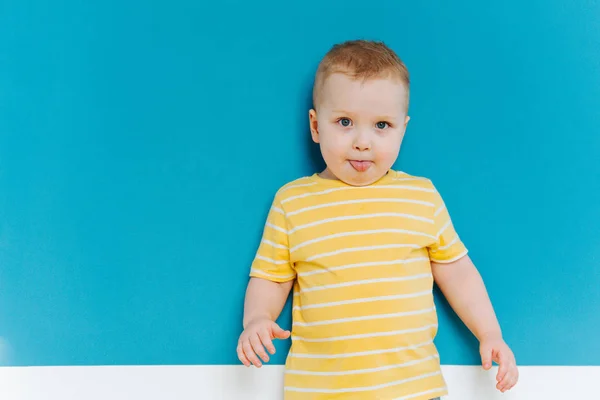 Portrait of cute shy blond little toddler boy in T-shirt — Stock Photo, Image