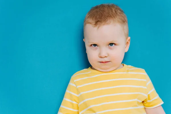 Portrait of cute shy blond little toddler boy in T-shirt — Stock Photo, Image