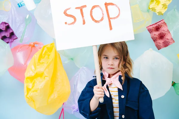 Little girl holding stop sign in protest against pollution and waste crisis — Stock Photo, Image