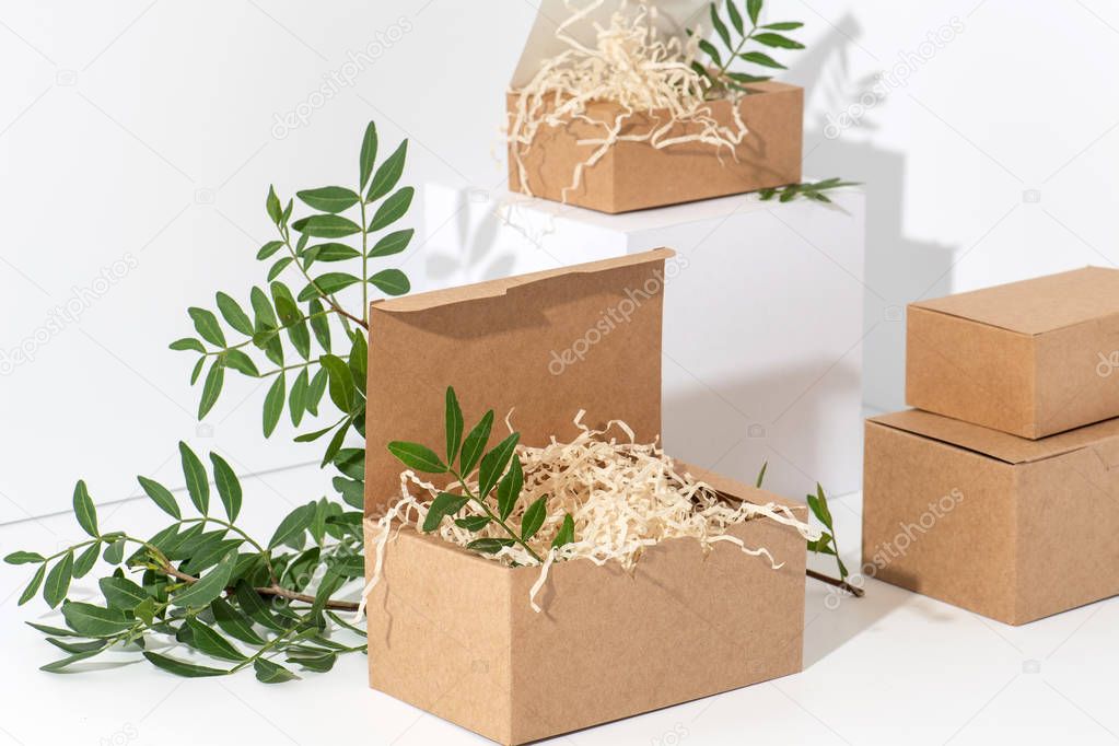 Disposable, recyclable paper boxes in the corner over white background