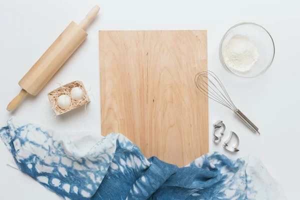 Baking tools and ingredients over white background