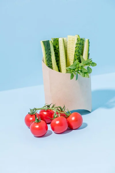 Fresh cucumbers in compostable paper hot food container — Stock Photo, Image