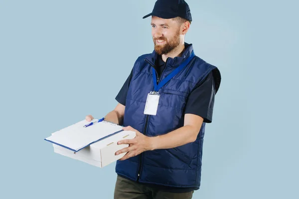 Courier entrega caixa, oferecendo-se para assinar um formulário de papel, que se encontra em cima da caixa . — Fotografia de Stock