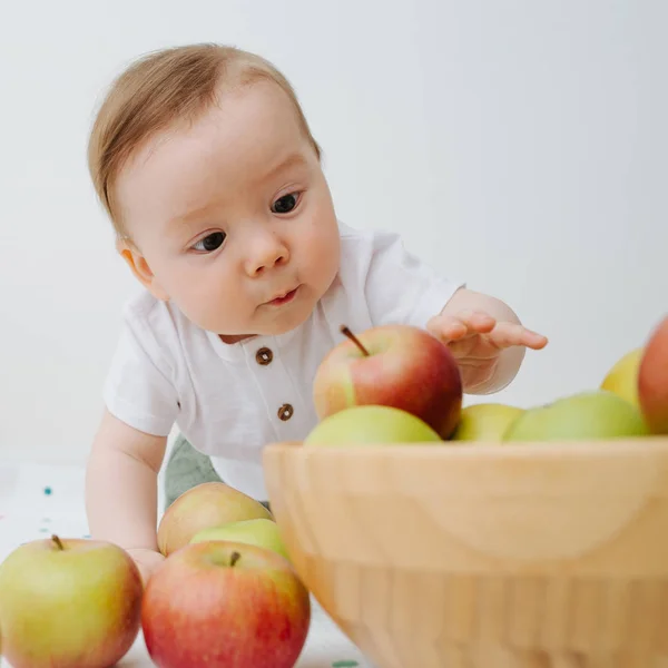 Portrait of a baby boy with apples