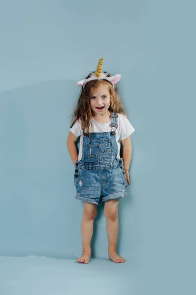 Menina brincalhão usando headband com chifre de unicórnio e orelhas — Fotografia de Stock