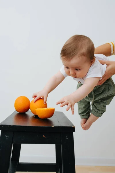 Image of Little boy grabbing juicy fruits — Stock Photo, Image