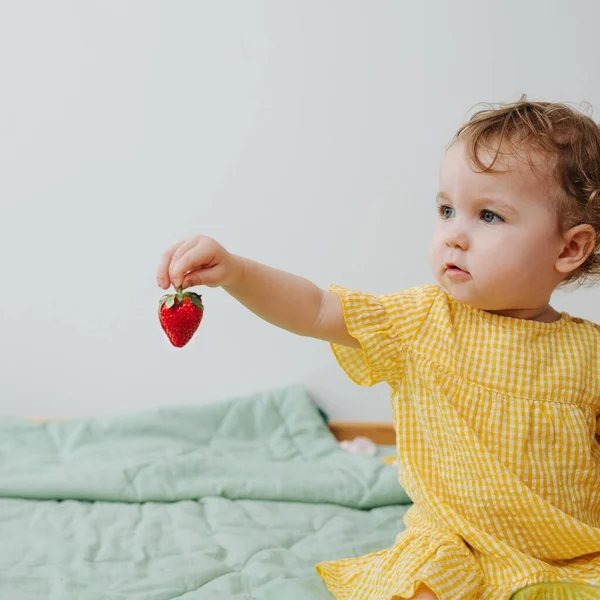 Beautiful girl playing with strawberry. Square close-up shot — Stock Photo, Image