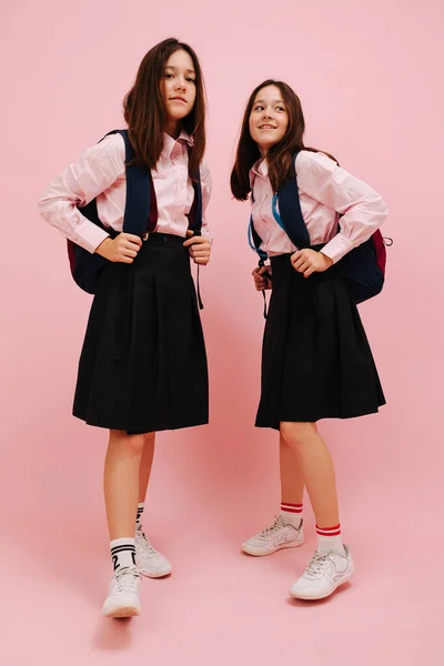 Beautiful Little Twin Schoolgirls Happily Posing Backpacks Low Angle Pink — Stock Photo, Image