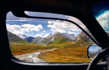 Landscape of beautiful mountain valley viewed from the car window. Travel and adventure concept. clipart