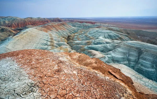 Bizarre layered blue and red mountains in desert park Altyn Emel in Kazakhstan