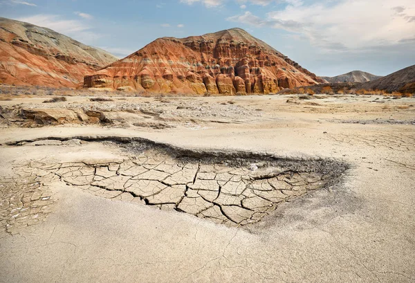 Red Mountains and cracked dry earth in the desert of Kazakhstan