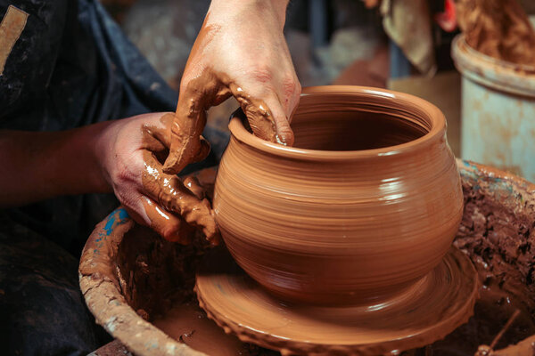 Potter at work. Workshop place.