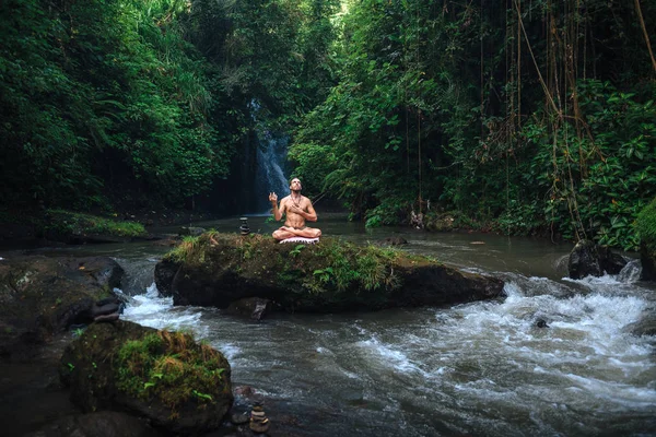 Yoga practice and meditation in nature. Man practicing near river — Stock Photo, Image
