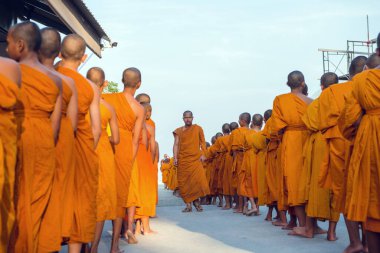 Tayland 'daki Phuket' teki Büyük Buda Tapınağı yakınlarında turuncu elbiseli genç Budistler. 28 Nisan 2019.