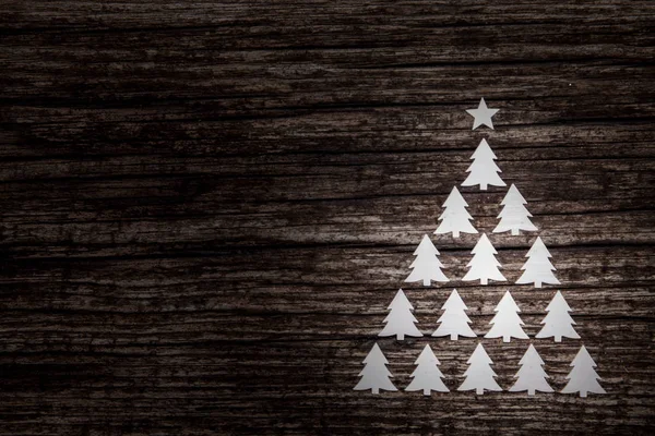 Christmas background. Three decorative fir on wooden background.