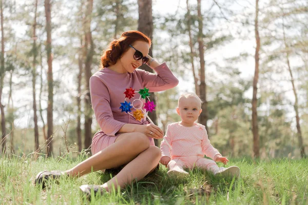 Girl Shows Child Toy Windmill Two Them Sitting Grass Park Stock Photo
