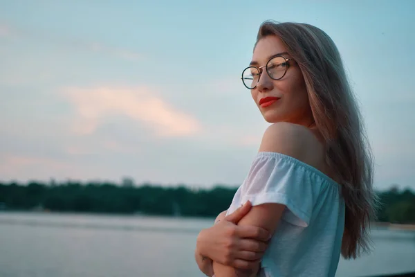 Muchacha atractiva con gafas en vista al lago parque —  Fotos de Stock