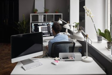 Genç zeki sakallı adam modern loft studio-görevliler çalışma