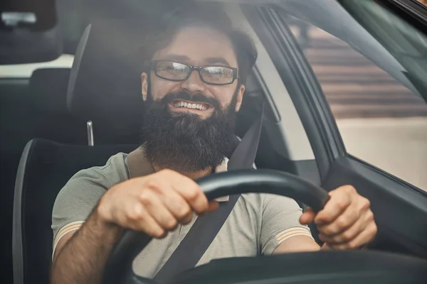 A modern bearded man driving a car — Stock Photo, Image